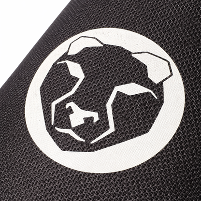 Close-up of Mammal Strength logo printed on ultra-stiff black CR neoprene knee sleeve fabric
